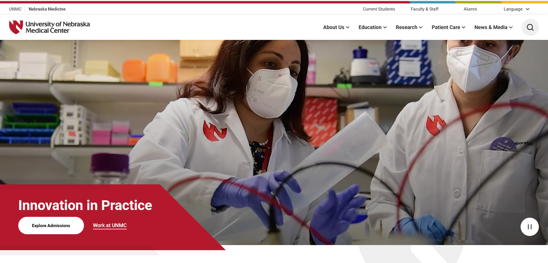 Screenshot of the University of Nebraska Medical Center home page containing a banner image with a faculty member demonstrating equipment use to a medical student.